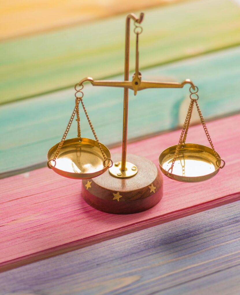 Scales of Justice sitting on top of colorful wooden planks